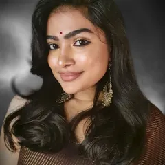 A festive look perfect for a sangeet or wedding guest. The focus is on warm, shimmery golden eyeshadow and defined eyes, paired with traditional chandbali earrings.
