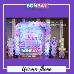 A magical unicorn theme for Kiana's first birthday. This beautiful setup features a custom backdrop, a pastel balloon arch, unicorn cutouts, and a light-up number '1'.