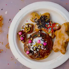 A plate of beautifully decorated gingerbread cookies from our Christmas workshop. Kids and adults have a great time getting creative with sprinkles and icing.