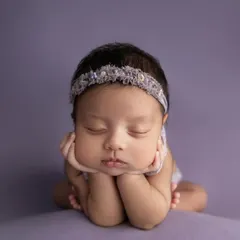 This is the magic of a classic newborn portrait. With gentle posing and soft lighting, I focus entirely on your baby's serene beauty, creating a simple, elegant, and timeless piece of art.