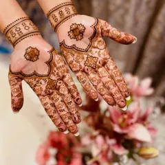 Subtle and sweet. This minimal bridal design features a lovely floral motif in the center of the palm with tiny elephants scattered around, paired with a simple wristband.