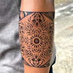 A dotwork mandala armband, showcasing another style of geometric tattooing. The shading is created entirely with tiny dots, giving the piece a soft texture and incredible depth.
