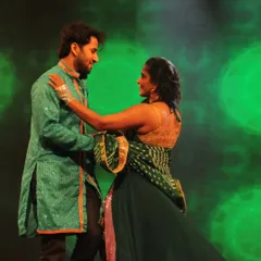 A quiet moment of connection in the middle of a stage performance. I choreograph these pauses into routines to let the couple share a look and just be with each other, creating a truly romantic memory.