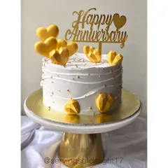 A simple yet elegant anniversary cake with textured buttercream and golden geometric hearts. This design is perfect for celebrating golden moments together.