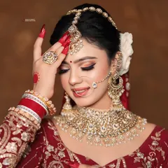A beautiful bridal portrait highlighting the harmony between the makeup, jewelry, and the bold red nails. Every element works together to create a look of timeless elegance.