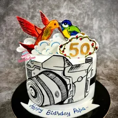 A truly unique, all-edible hand-painted cake created for a wildlife photographer's 50th birthday. The comic-style camera and colourful birds on top showcase my passion for turning your hobbies into delicious art.