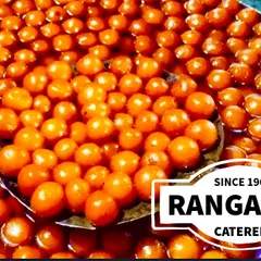 A large cauldron filled with freshly made Gulab Jamuns, soaking in sweet syrup. This shows our capacity to handle large-scale catering for weddings and festivals without compromising on quality.