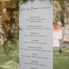 It’s the little details that truly bring the wedding vision to life. This custom bar menu, adorned with a delicate floral arrangement, added a personal and stylish touch to the garden bar.