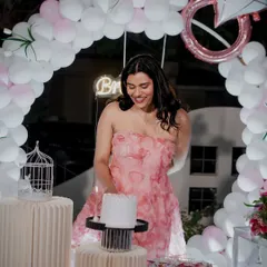 The bride-to-be enjoying her cake cutting moment under a balloon arch featuring a diamond ring balloon, a perfect touch for a bridal shower.