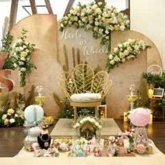 A closer look at our popular "Heels or Wheels" gender reveal theme. This setup combines rustic wooden backdrops with soft florals, pampas grass, and a statement chair, offering a stylish and sophisticated alternative to traditional color schemes.