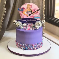 Sparkles, sprinkles, and a whole lot of style! This purple disco-pop cake, inspired by a pop icon, is perfect for a 10th birthday, complete with glitter balls and cassette vibes.