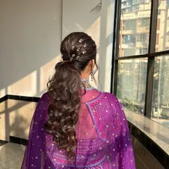 A modern and edgy ponytail for a Sangeet. I've used crystal accessories to create a studded effect, adding a touch of sparkle and making the hairstyle a true statement piece.