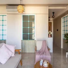 Beauty is in the details. Here, a pop of teal on the doors adds a playful contrast to the neutral tones and wooden textures, showcasing our approach to balancing client preferences with our design vision.