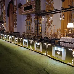 A long shot of our illuminated buffet counter in a grand hall. The integrated lighting and ornate details of the counter itself add a layer of sophistication to the entire dining experience.