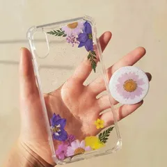 A delicate floral phone case with a matching pop socket. I used pressed purple and yellow flowers to create a simple, elegant design on a clear case.