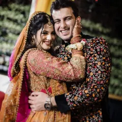 The vibrant colors and joyful energy of a Mehendi ceremony are on full display in this happy couple's portrait. It's a beautiful capture of a North Indian pre-wedding celebration.