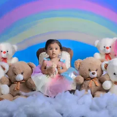 A wider view of our rainbow and clouds setup. This enchanting theme is perfect for a whimsical and colorful baby photoshoot, complete with balloons and lots of teddy bears.