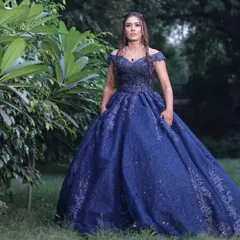 A full view of the fairytale engagement gown. The makeup is kept elegant and timeless with soft waves in her hair, perfect for this grand celebration.