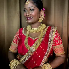 The bride's radiant smile says it all. The makeup enhances her features while celebrating her beautiful skin tone.