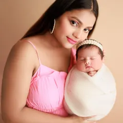Big love and endless blessings. This beautiful mother-and-newborn portrait showcases the pride and joy of a new Amma holding her precious baby.