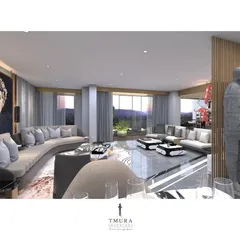 This expansive living room is designed for large gatherings, featuring multiple seating areas with custom curved sofas. A life-sized sculpture and a large mosaic artwork act as focal points, demonstrating how we integrate art into our interior architecture.