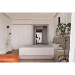 The master bedroom was designed to capture the golden hour sunset. We used beautiful smooth curves in the architecture and cabinetry to create a soft, enveloping feel, making the room a serene retreat that flows seamlessly onto the outdoor deck.