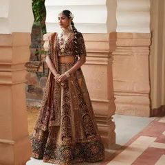 For this heritage look, I styled a bride in a rich, multi-textured velvet lehenga. The intricate zardozi work and traditional braid hairstyle, adorned with flowers, evoke a sense of old-world charm and grandeur.