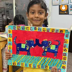 Inspired by traditional Indian art, this painting of two elephants is wonderfully symmetrical and vibrant. The student did a fantastic job with the bold red background and decorative borders.