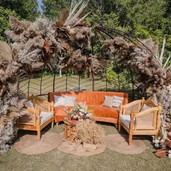 This minimal boho lounge is an example of our 'Wild & Warm' design style. We used earthy tones, pampas grass, and natural wood textures to create a soulful corner for quiet conversations and beautiful photo opportunities.