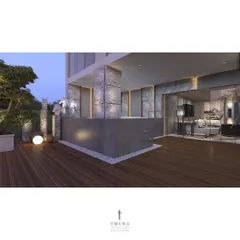A view of the penthouse terrace at dusk, showing the custom outdoor bar and stone-clad pillars with integrated uplighting. The design seamlessly connects to the indoor lounge through floor-to-ceiling glass doors.