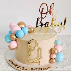 "Diapers & Pins, the fun begins." This baby shower cake uses a lovely beige base with pink, blue, and gold balloon clusters to celebrate the new arrival. The acrylic mom-to-be silhouette adds a personal touch.