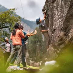 Teamwork makes the dream work. Here, our crew is focused on spotting a climber as she navigates a tricky bouldering problem in Sethan. We always prioritize safety and mutual support.