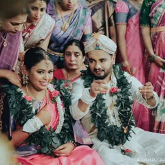 A candid moment from a South Indian wedding ceremony, capturing the bride's happy expression as the groom performs a ritual. These are the unscripted memories I love to freeze.