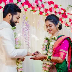 A beautiful shot of Asawari and Amit exchanging rings, framed by a stunning floral arch. This is a key moment I always ensure to capture perfectly.