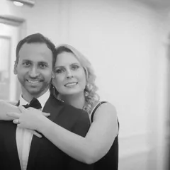 A warm and loving embrace captured in timeless black and white. This indoor pre-wedding portrait is simple and elegant, focusing entirely on the couple's happy expressions and connection.
