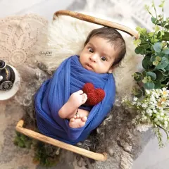 Those big, curious eyes are so captivating. Even when babies are swaddled, their expressive faces can tell a whole story.