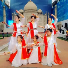 Our classical dance team posing in front of a beautiful backdrop before their stage performance.