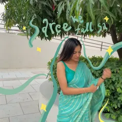 A beautiful turquoise saree moment, with green doodles and sparkles that make it feel like a scene from a movie.