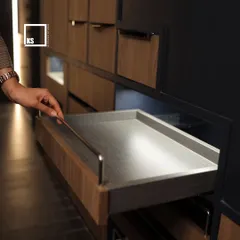 A shallow pull-out tray is perfect for organizing smaller items or serving accessories, ensuring nothing gets lost in the back of the cabinet.