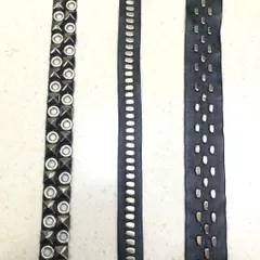 Three styles of modern studded laces on a black leather-like base. These trims are perfect for adding detail to jackets, trousers, or accessories for a contemporary, edgy look.