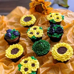 Where flowers bloom, so does hope! A beautiful assortment of floral cupcakes, including piped buttercream sunflowers, roses, and other botanical designs.