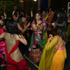 The dance floor is packed during a vibrant Garba night. I love seeing the crowd, dressed in colorful traditional attire, enjoying the music and dancing together.