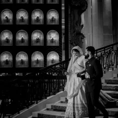 The quiet grace of a Nikah ceremony. This black and white photo of the couple on the stairs captures a moment of serene elegance and the beginning of their journey together.