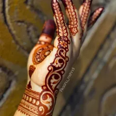 This image captures the deep, rich color of a mature henna stain. The Arabic-style paisley and floral vine looks stunning with this dark and even coloration.