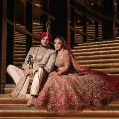 A portrait of regal elegance, where every detail tells a story of heritage and love. This moment from a grand Sikh wedding captures the couple's majestic presence against a backdrop of architectural splendor. My goal is to create timeless portraits that feel like a part of your family's legacy.