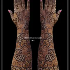 Another example of a heavy Indo-floral design, this mehendi features layers of intricate patterns from the elbow to the fingertips. The symmetrical layout ensures a balanced and cohesive look.