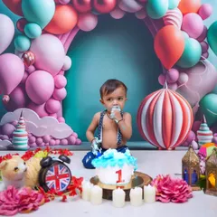 A cake smash is the most fun way to celebrate a first birthday! This little one is enjoying his first taste of cake in a whimsical, candy-themed setup at my Vashi studio.