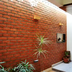 The atrium wall is made of exposed brick, creating a rustic and earthy feel. The skylight above ensures this central space is always bright and welcoming.