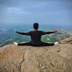 Finding balance and stillness with Samakonasana at the peak of Savanadurga hill. Reaching the summit of a trek is not just a physical achievement; it is a chance to connect with the vastness around you and the stillness within. This is a moment of pure presence.