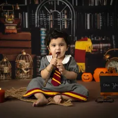 It's not just for Harry. This little girl makes a perfect Hermione Granger, captured in our Hogwarts library set for her first birthday.